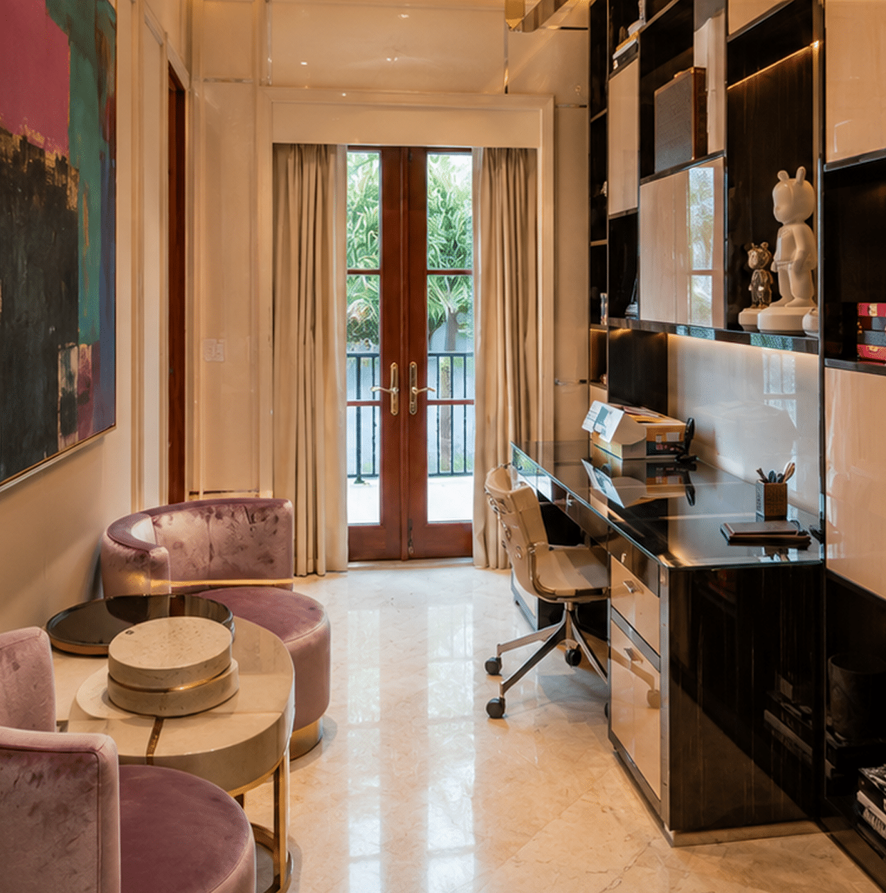 A luxurious home office with a black desk, rolling chair, and purple velvet seating, facing French doors.